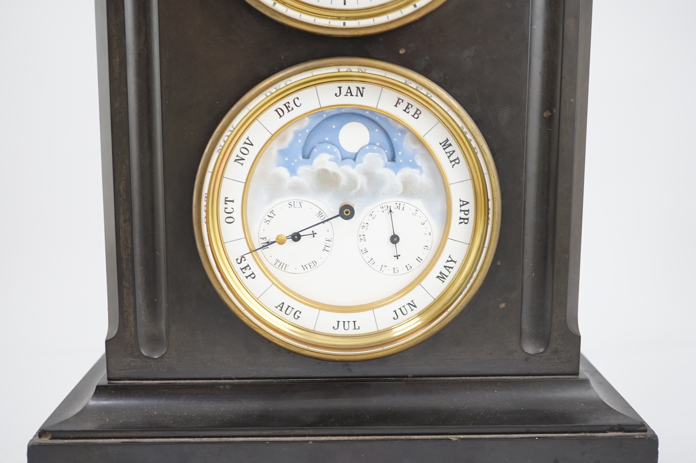 A late 19th century French black slate calendar mantel clock